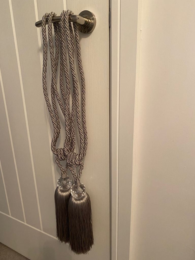Silver coloured curtain tie backs