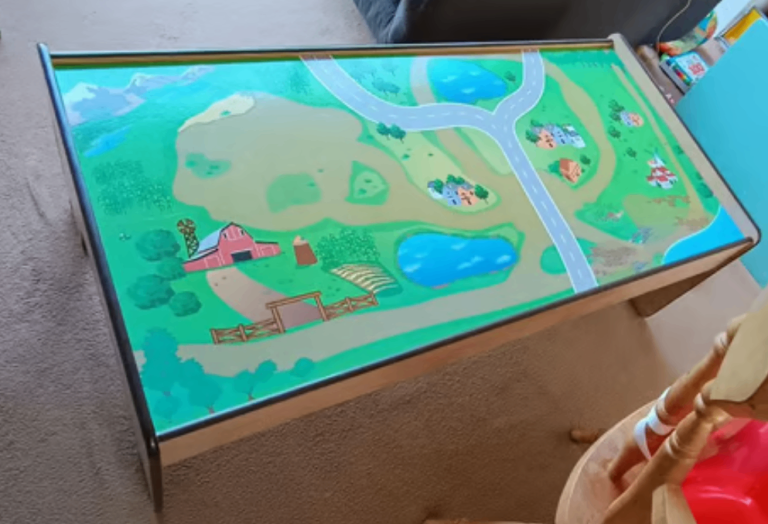 Wooden table with farm and roads on the top