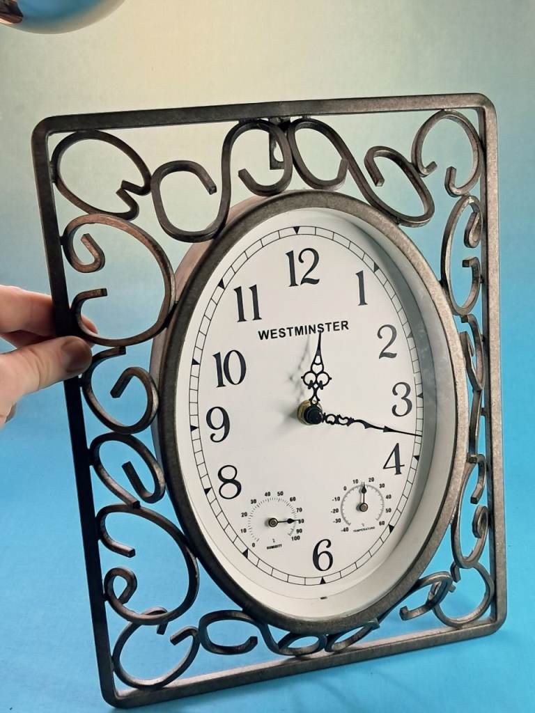Westminster brand decorative analog wall clock featuring a scrollwork metal frame