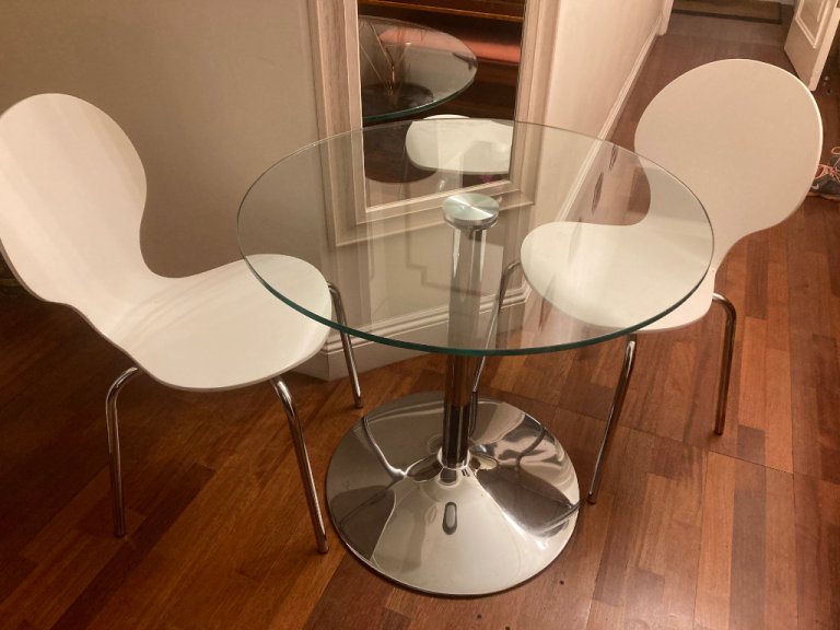 Contemporary glass top table with two chairs can deliver