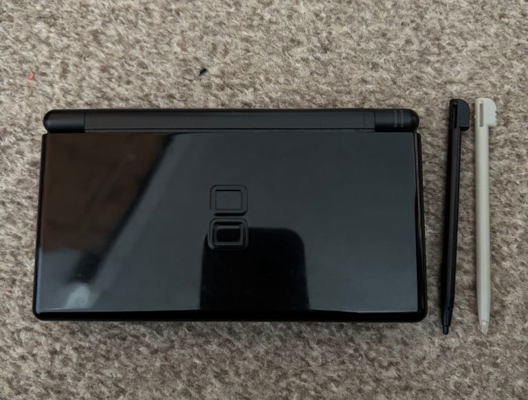 Nintendo DS Lite in black inc. Charger, Carry Case, 17 games, 2 stylus & 8 cartridge cases