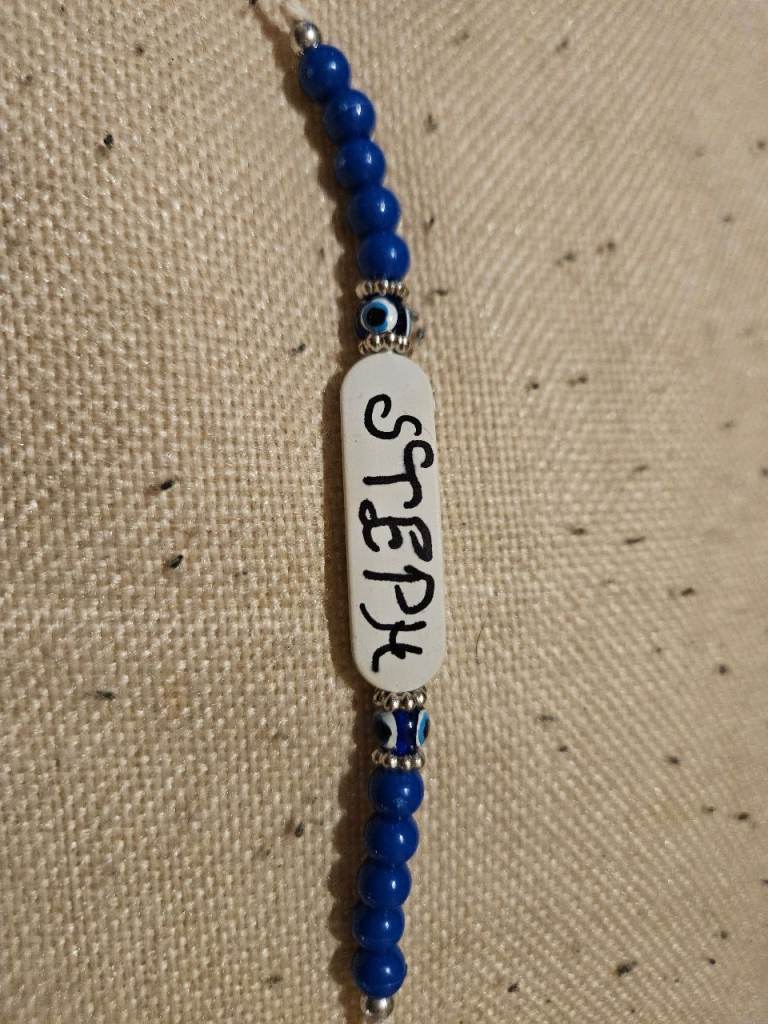 Eveil eye braclet with name steph on it.