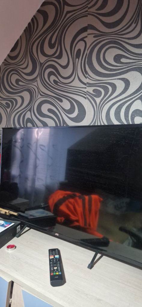 Large Black Flatscreen TV with Remote Control
