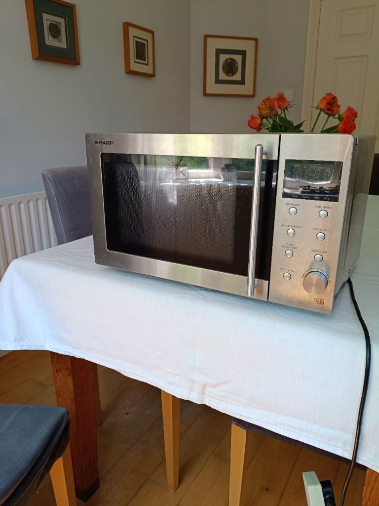 Sharp R28STM microwave oven with touch control and LED display in stainless steel finish.