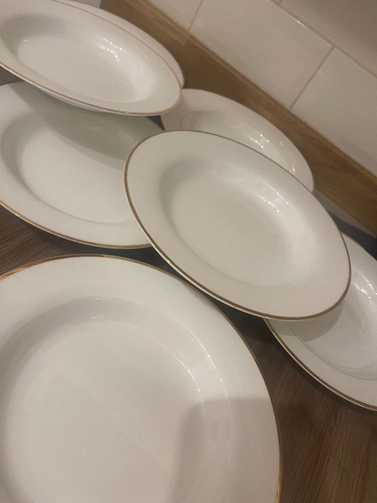 Eight soup bowls with gold rim 