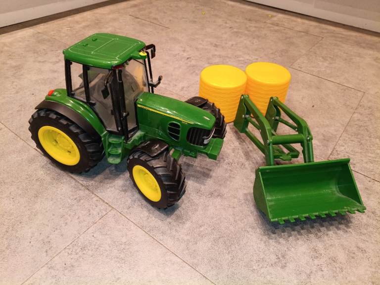 John Deere light and sound tractor by Britains ERTL, with accessories