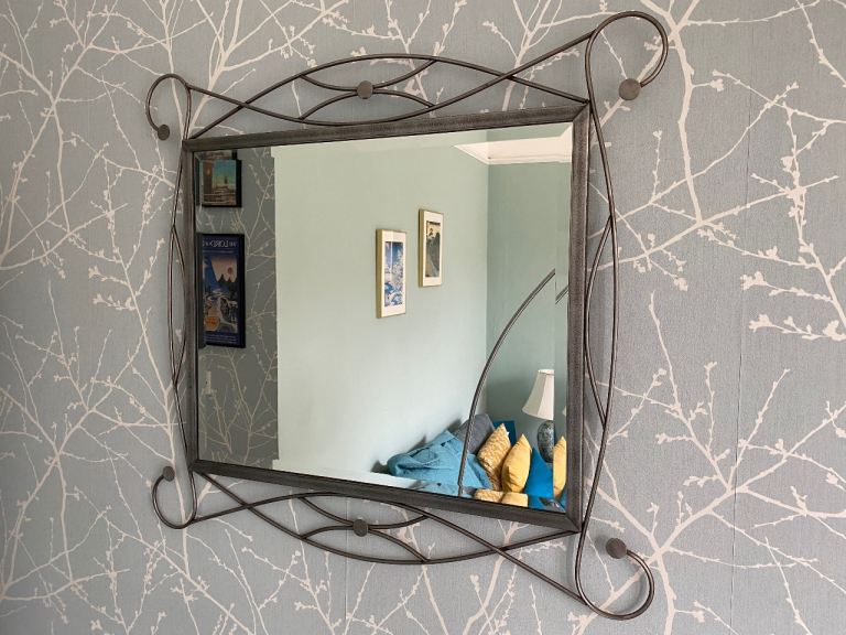 Stylish wall mirror with wrought iron frame 