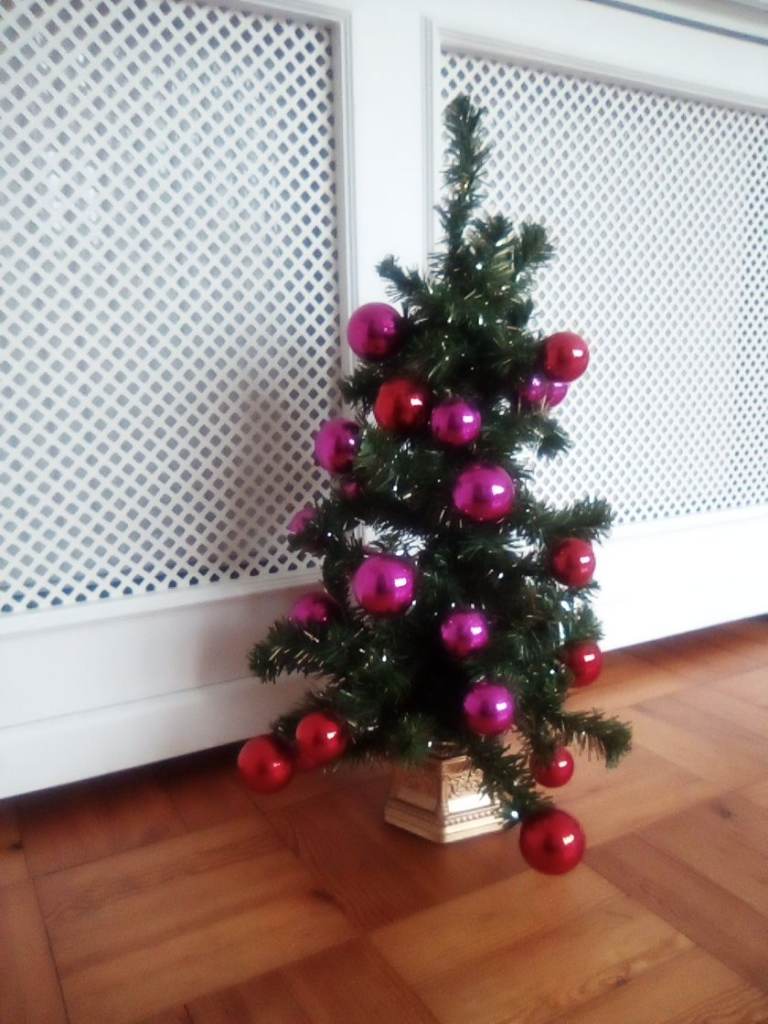 John Lewis small artificial Christmas tree, with bauble and other decorations.