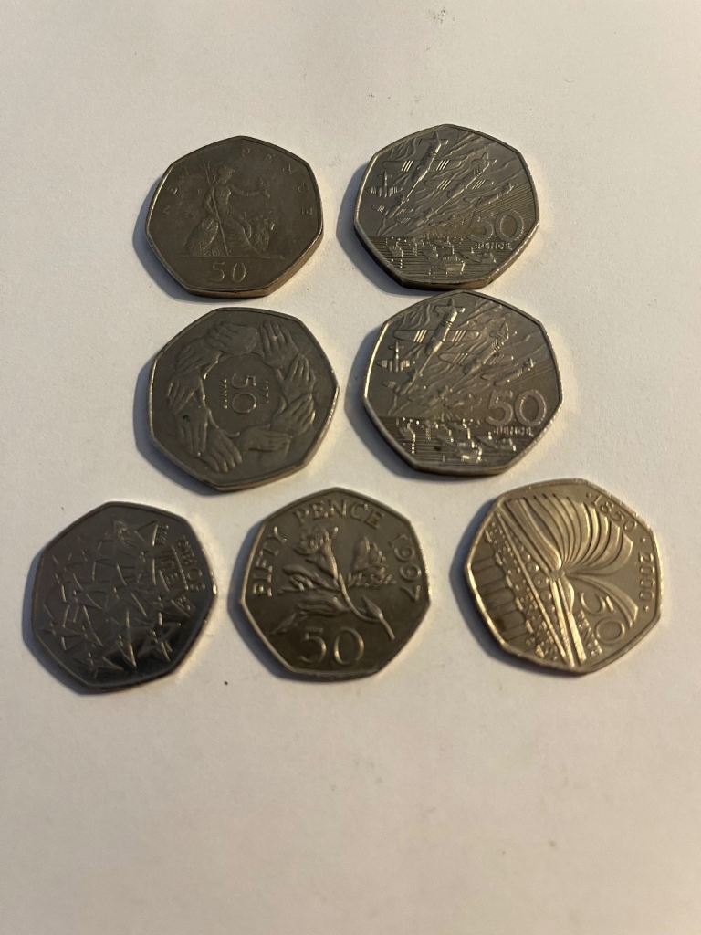 Price reduction.    7 commemorative 50p coins