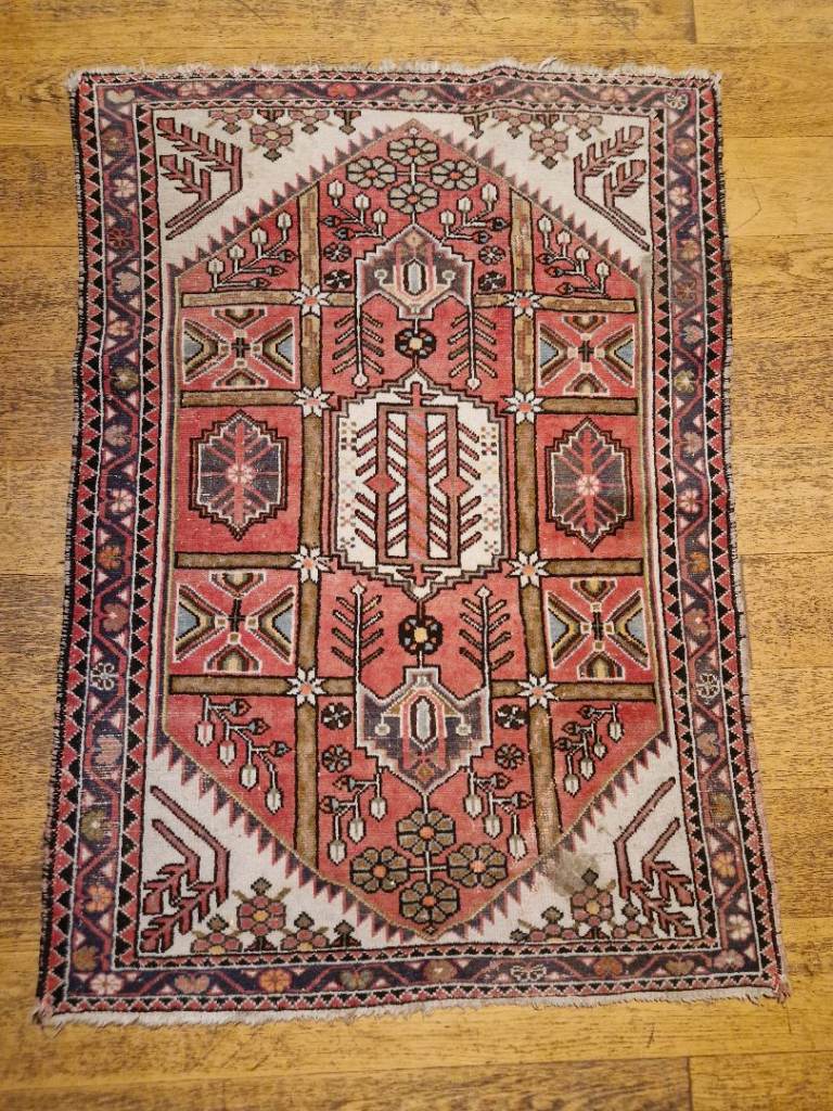 an antique handmade wool persian rug 