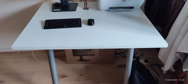 Office Table with white top and iron legs, manual height adjustable.