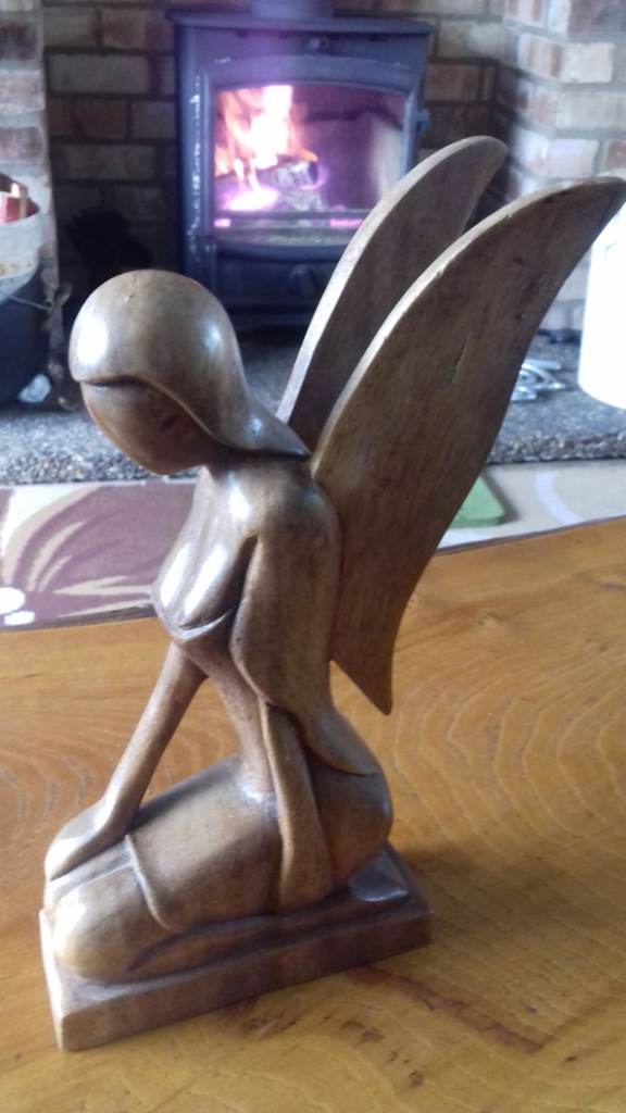 Wooden Seated angel and singing monk