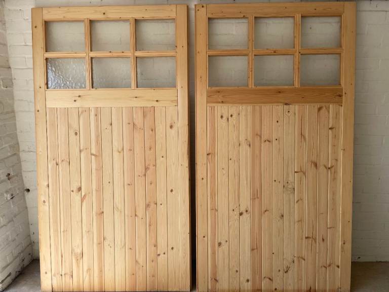 Brand new unused Jeldwen garage door pair.  Standard 7ft wide, 6ft 6" high.  Safety glass.