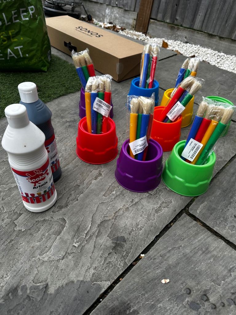 Paint brushes, paint and pots for art and craft