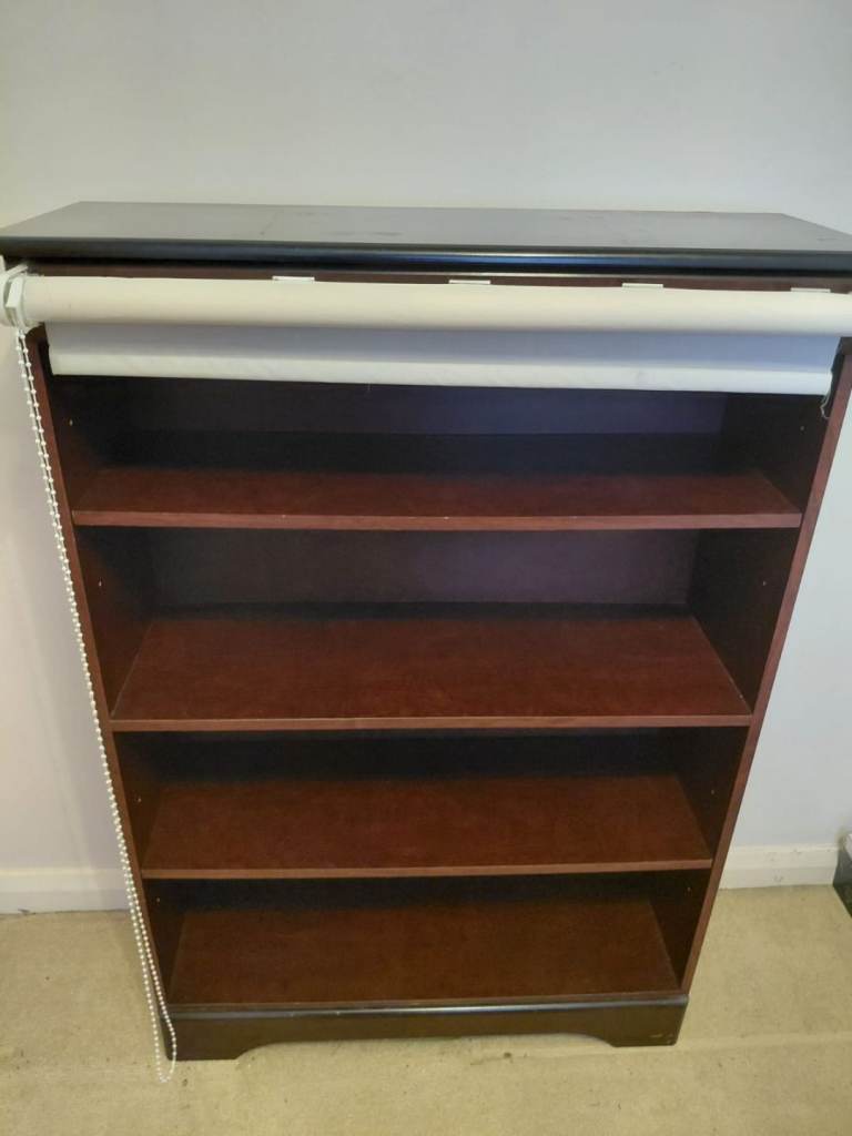 Bookshelf with roller blind