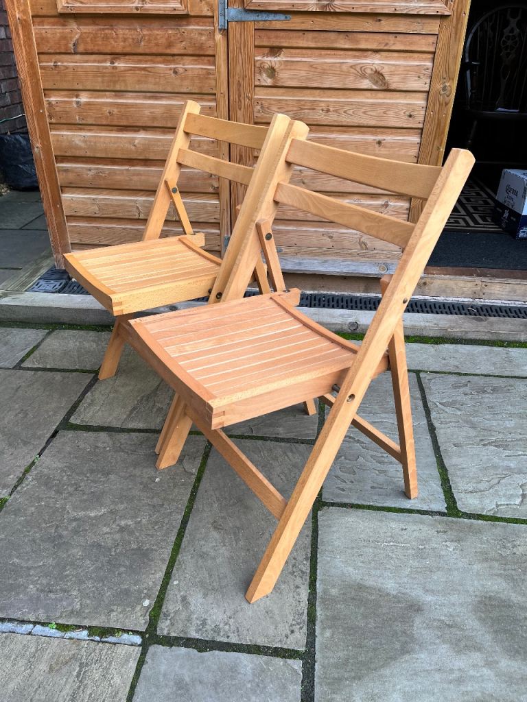 image for Two hardly used and identical  wooden folding chairs