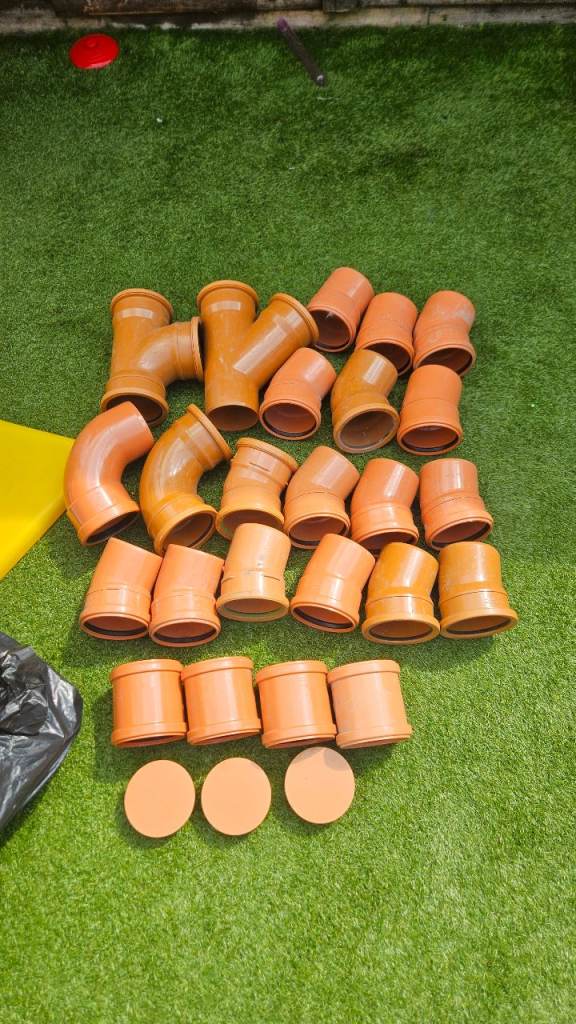Selection of Orange Plastic Drainage Pipes and Connectors