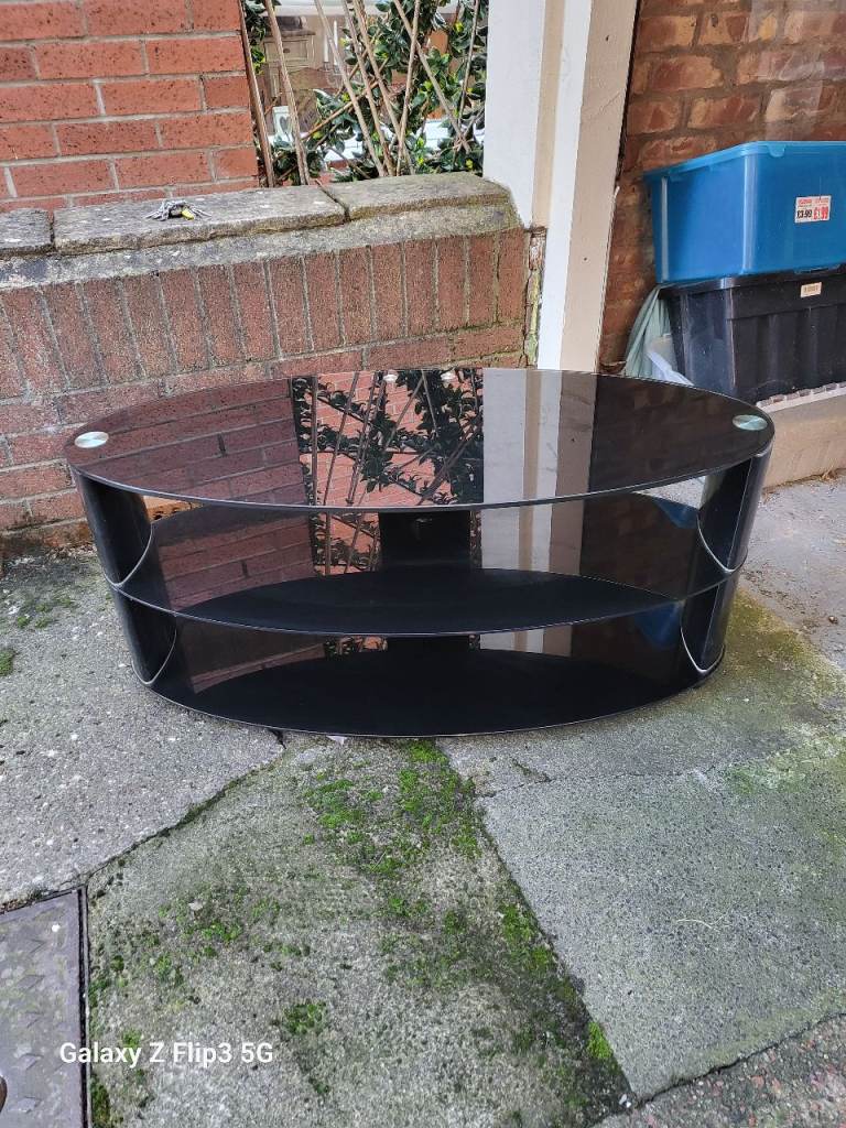 Gorgeous oval black glass tv stand