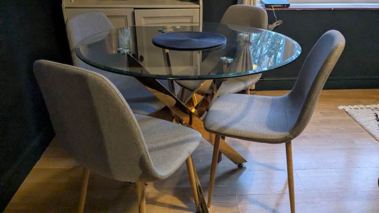 image for Glass round table with fabric grey chairs 