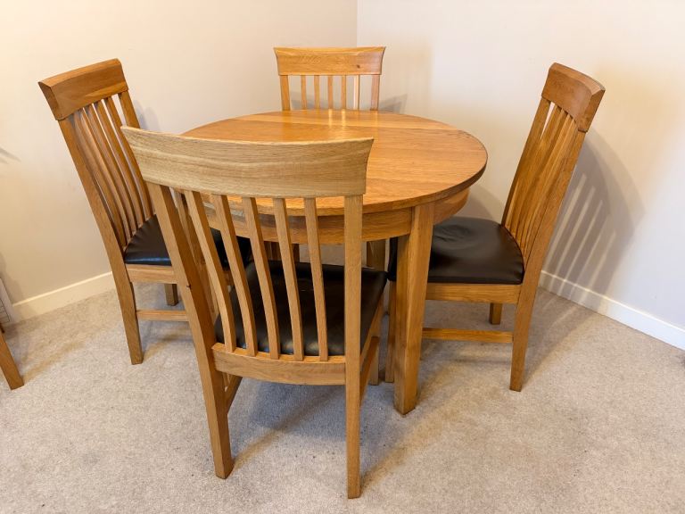 Oak circular dining table and 4 matching chairs