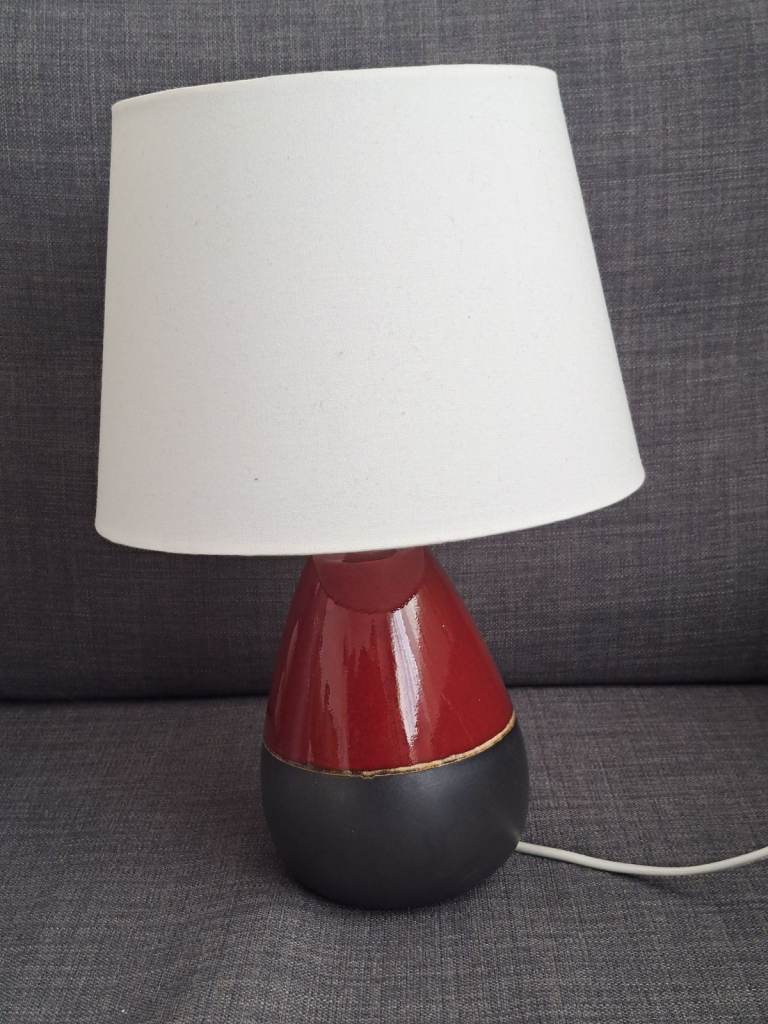 Burgundy table lamp and lampshades.