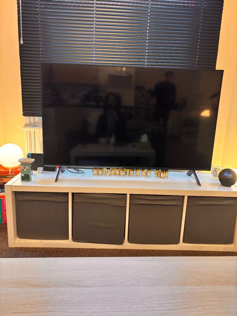 IKEA white kallax 4*1 with the grey storage boxes 