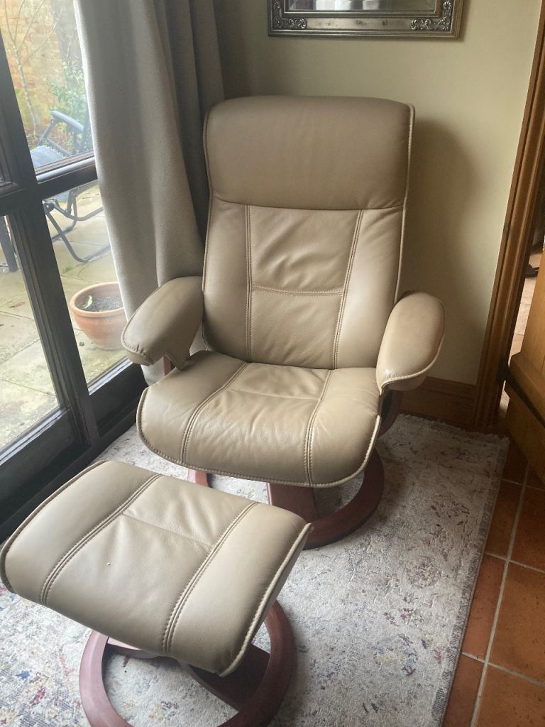 Swivel recliner chair with footstool 