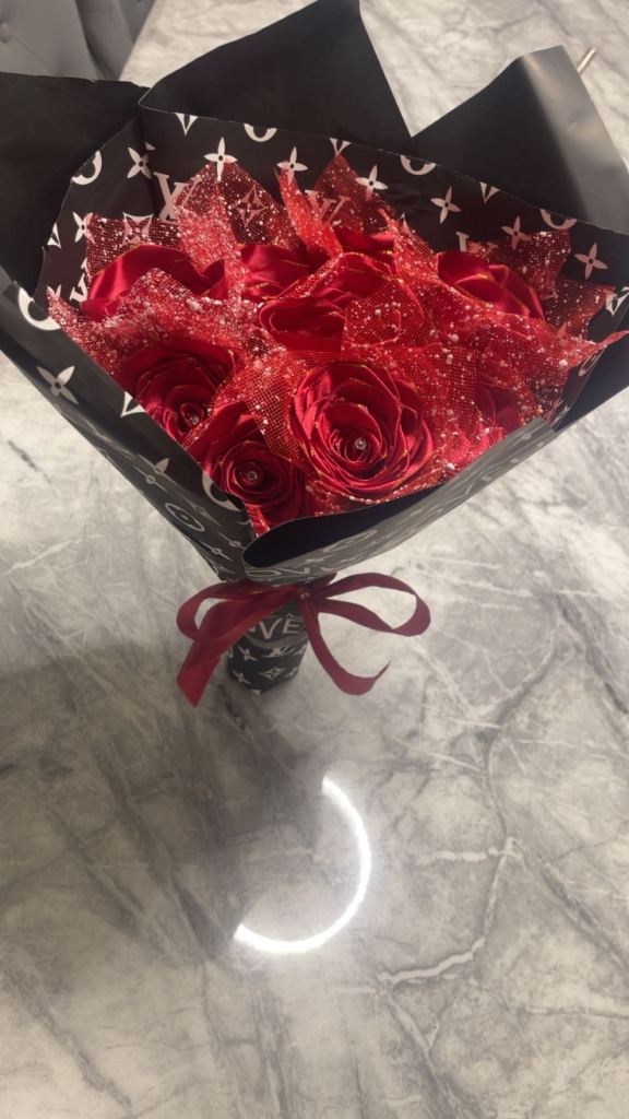 Red roses with diamonds on it wrapped in paper