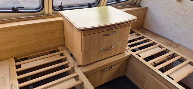 Centre drawer with folding table and bed slats.