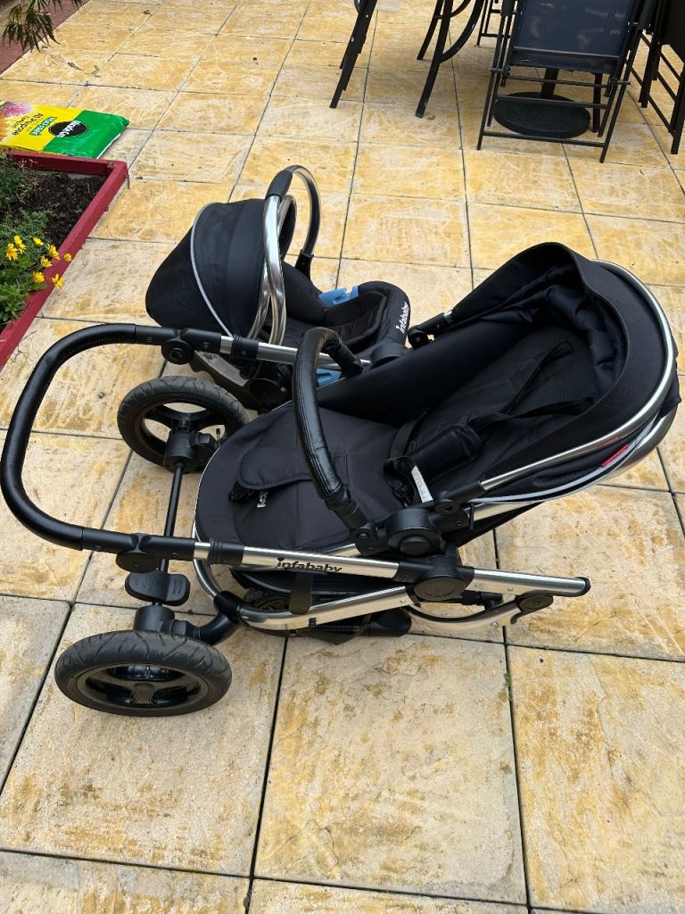 Black Infababy pushchair and car seat set and cover 