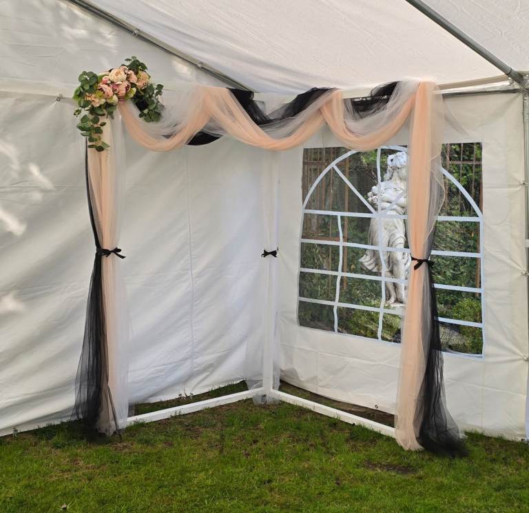 Wedding arch backdrop floral voil display.