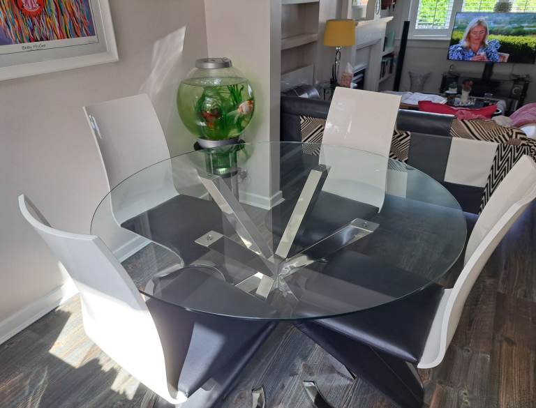 Large round glass table (140 cms) with four chairs.