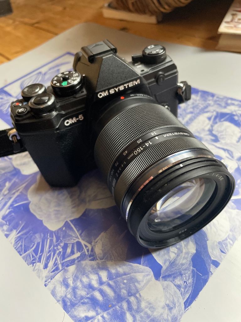 As New Olympus OM-5 with 14-150mm lens