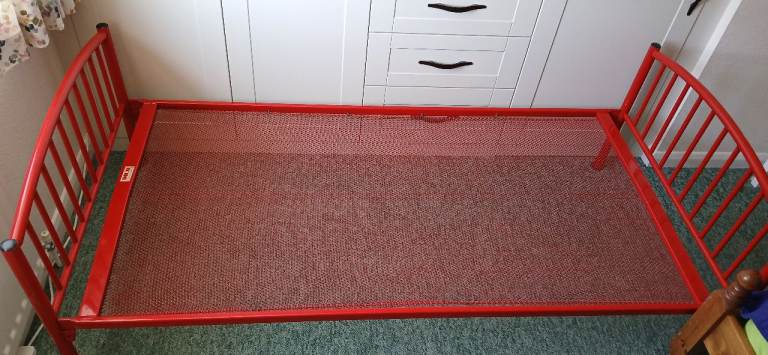 Red tubular steel bed