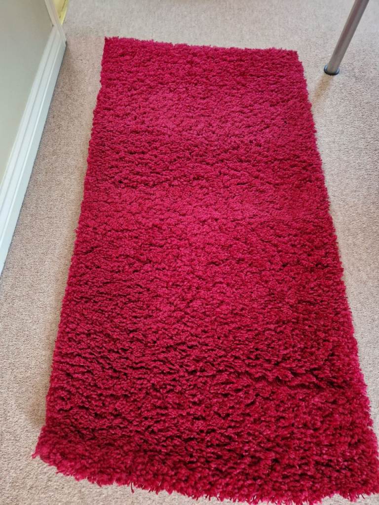 Burgundy coloured small rug