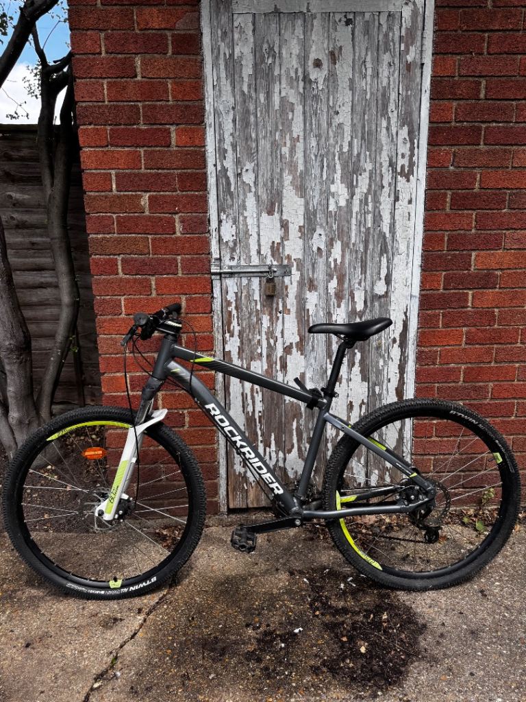 ROCKRIDER Mountain Bike – Grey with Yellow Accents, Good Condition