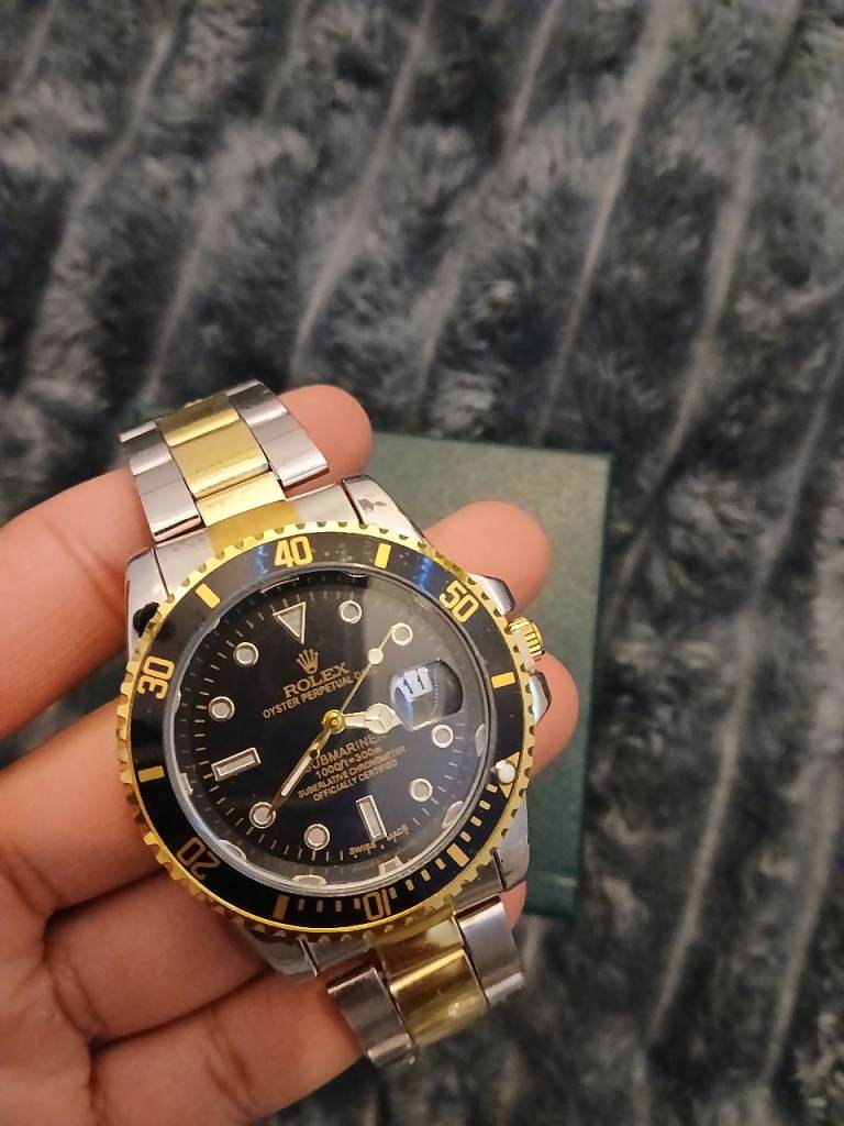 Mens black and gold watch