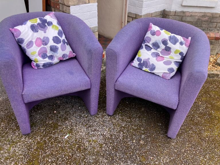 Pair of matching purple bucket chairs with cushions