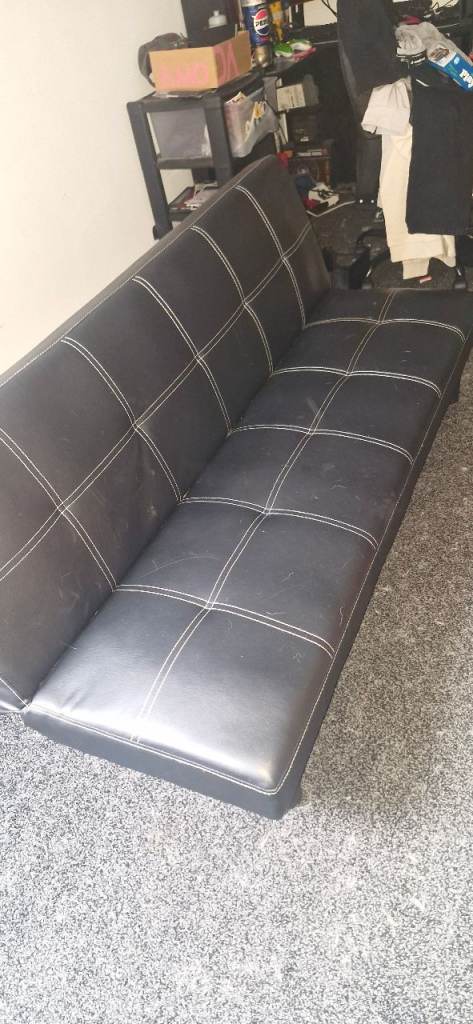 Black faux leather sofa bed folds into small double