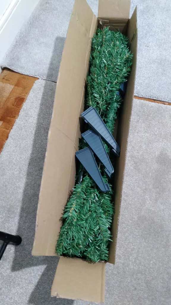 Artificial Christmas tree with decorations for sale.
