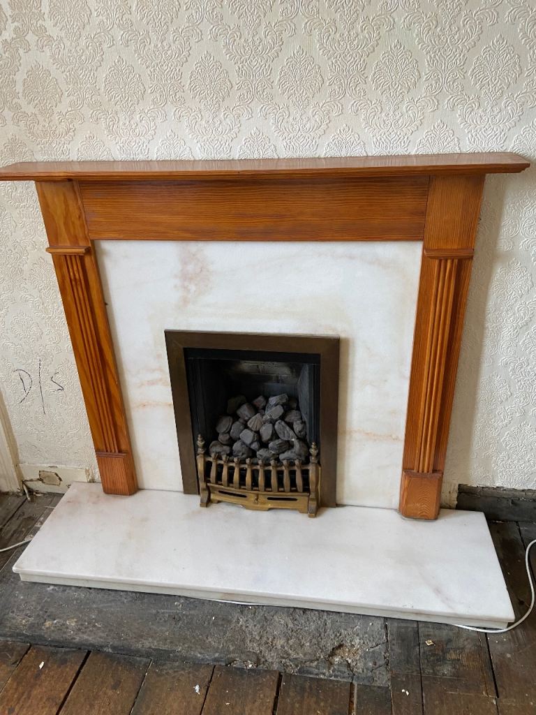 Fireplace with living flame gas fire and marble surround and hearth