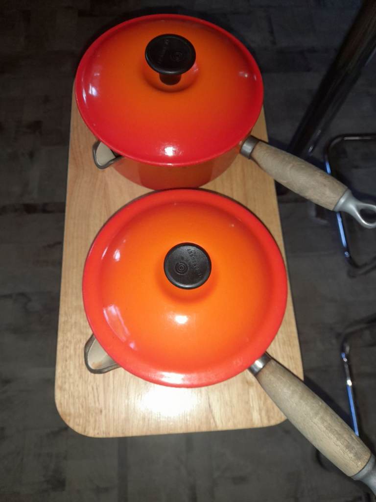Le Creuset Volcanic Orange pans with lids
