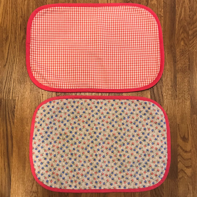 2 vintage handmade identical, double-sided, padded fabric placemats. £5 ovno both. Can post.