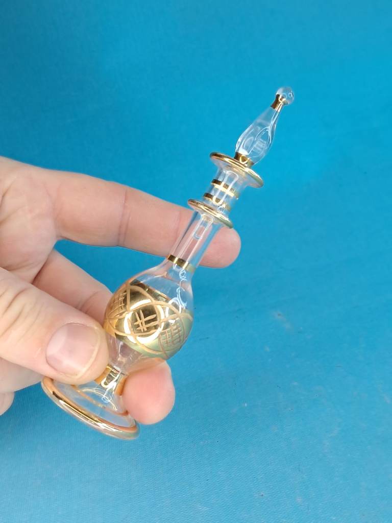 Egyptian hand-blown glass perfume bottle.  intricate etched glass detailing and 14K gold accents.
