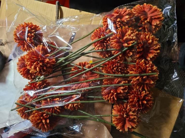 Burnt orange artifical flowers and greenery unused from wedding