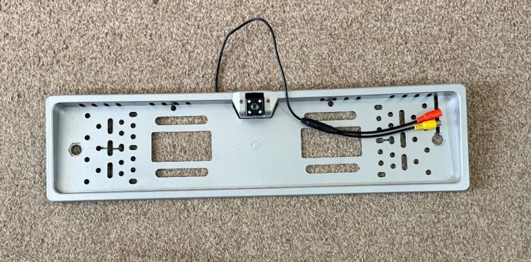 car license plate frame with a built-in rear backup camera 