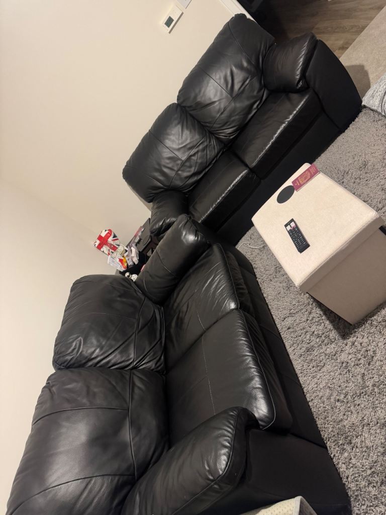 Two black 3 seater sofas 