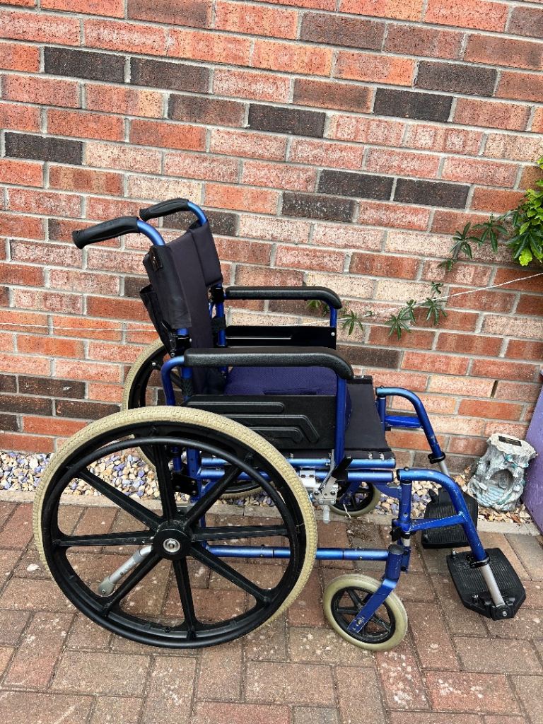 Worldwide mobility manual wheelchair blue black padded cushion folds flat 