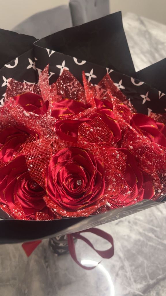 Red roses with diamonds on it wrapped in paper