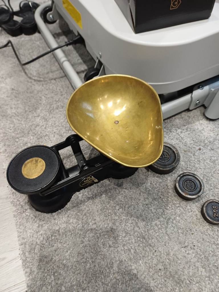 A set of shop scales with  brass pan and complete set of weights.